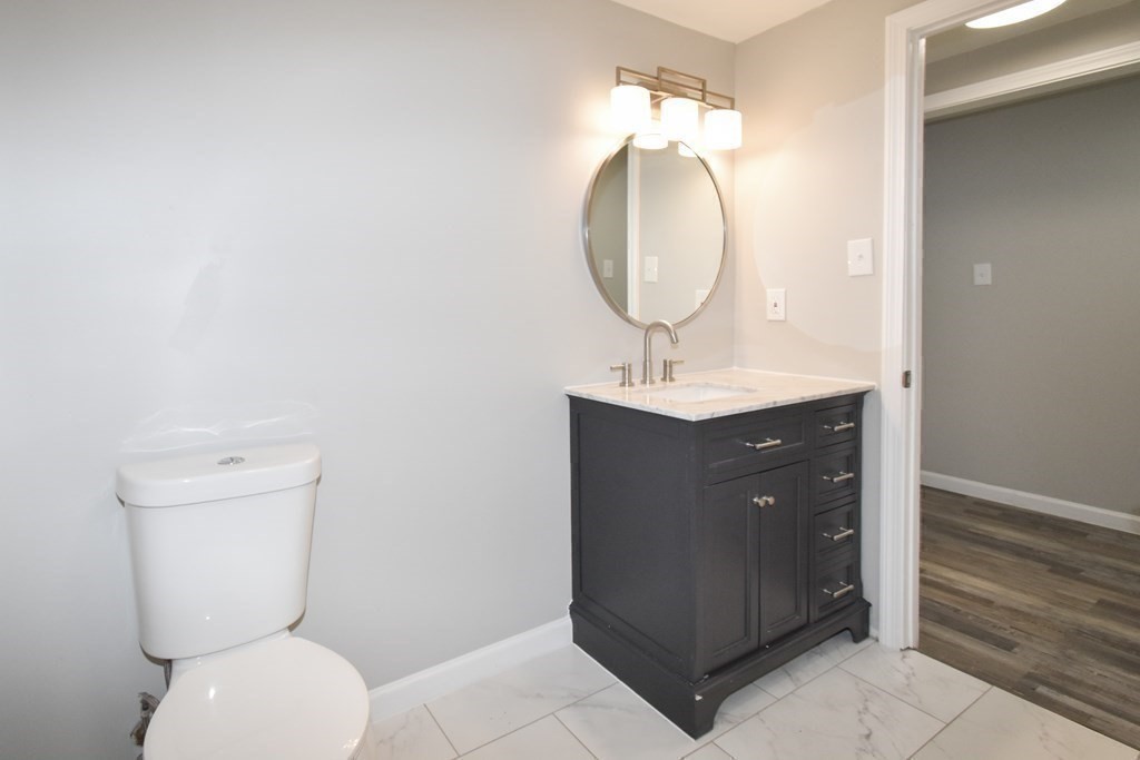 1094 Sumner Avenue Springfield, MA 01118 - Photo 21 of 35 a bathroom with a toilet a sink and mirror