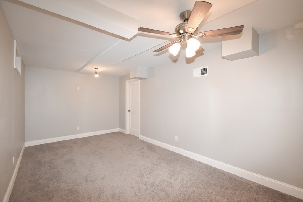 1094 Sumner Avenue Springfield, MA 01118 - Photo 33 of 35 an empty room with windows and fan
