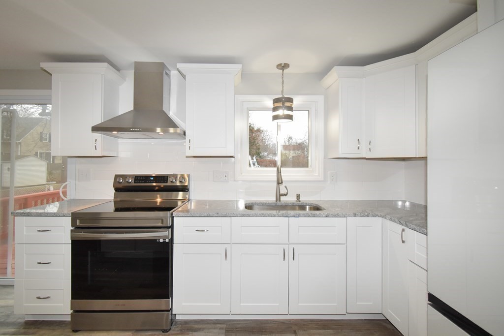 1094 Sumner Avenue Springfield, MA 01118 - Photo 5 of 35 a kitchen with stainless steel appliances a sink stove and cabinets