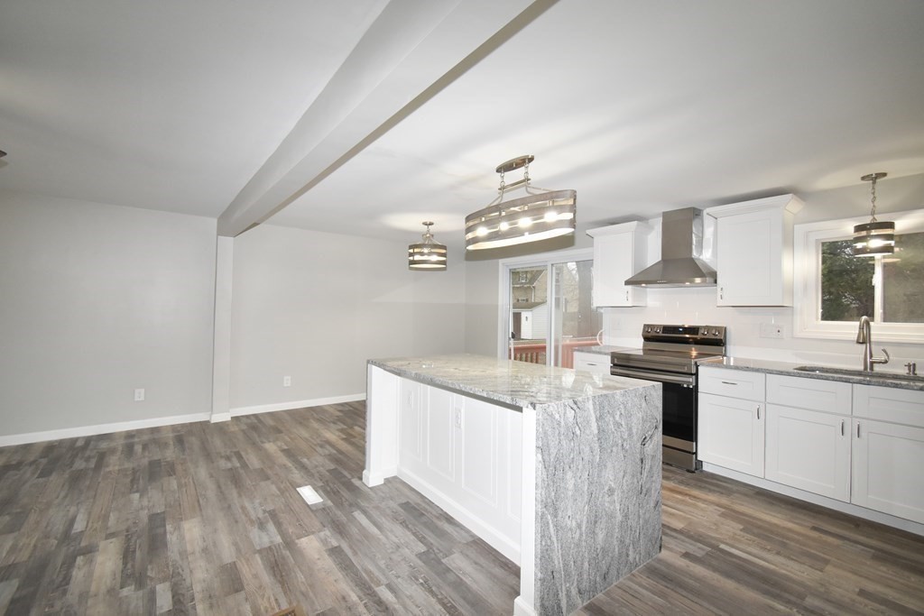 1094 Sumner Avenue Springfield, MA 01118 - Photo 7 of 35 a kitchen with granite countertop a sink stove and cabinets