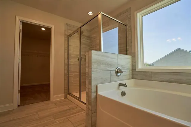 a bathroom with a shower and closet