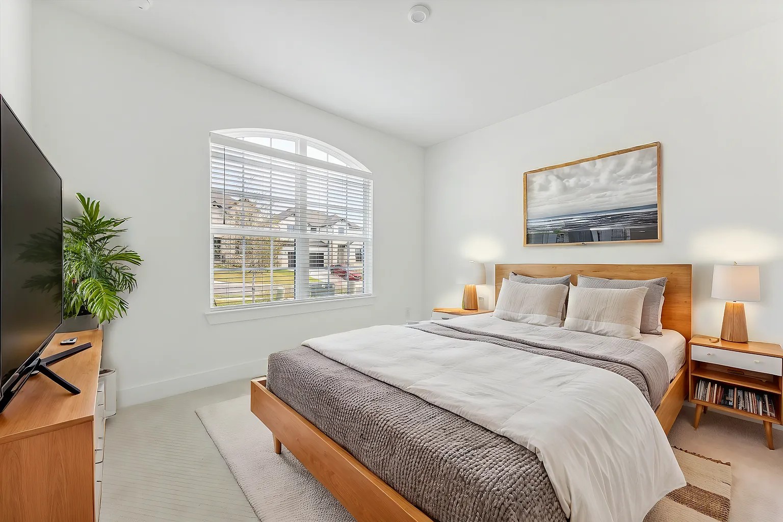 1909 Varese Path Leander, TX 78641 - Photo 35 of 40 Natural light pours into this spacious bedroom through a charming arched window, creating a serene retreat.