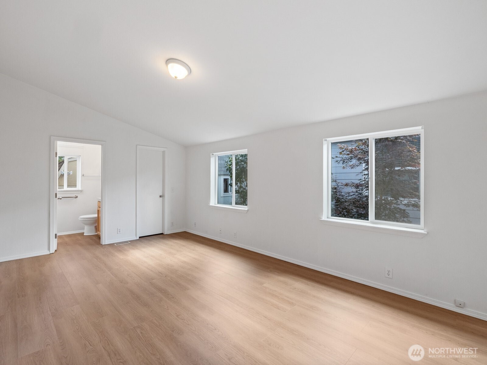 23825 15th Avenue Southeast, Unit 159 Bothell, WA 98021 - Photo 13 of 20 a view of an empty room with a window and wooden floor