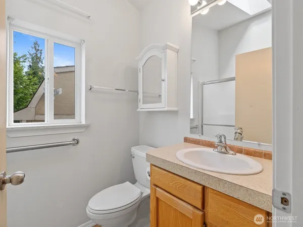 a bathroom with a sink toilet and a mirror