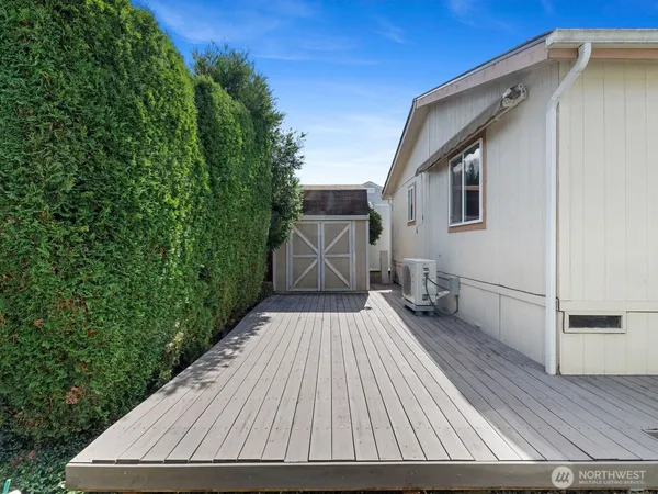 a view of backyard with wooden floor and fence