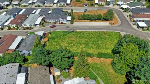 an aerial view of multiple houses with yard