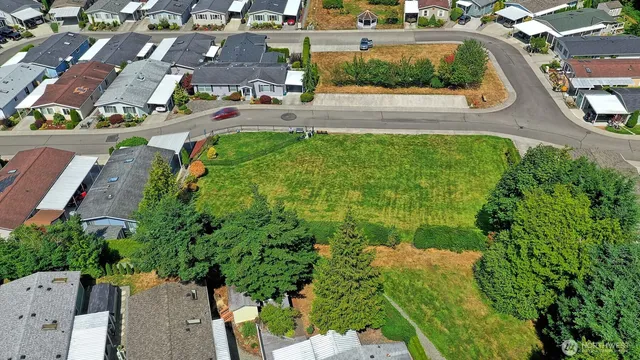 an aerial view of multiple houses with yard