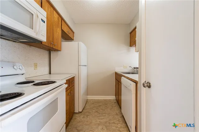 a utility room with cabinets washer and dryer