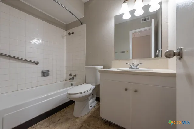 a bathroom with a double vanity sink mirror and toilet