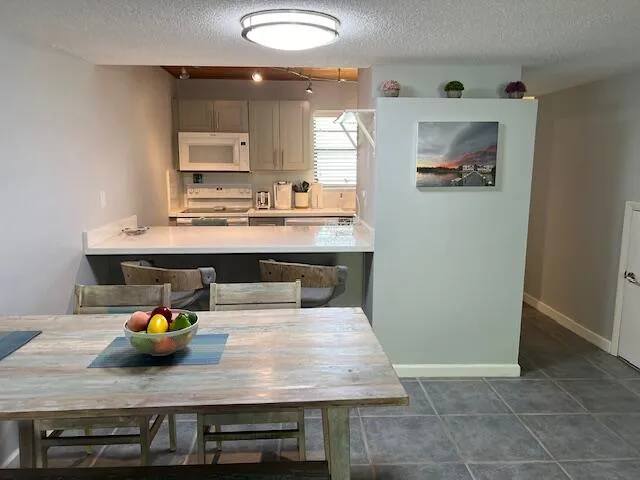 a kitchen that has a microwave a sink and a stove