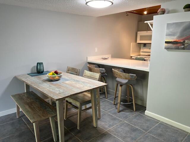 87465 Old Highway, Unit 224 Islamorada, FL 33036 - Photo 13 of 39 a view of a dining room with furniture and wooden floor