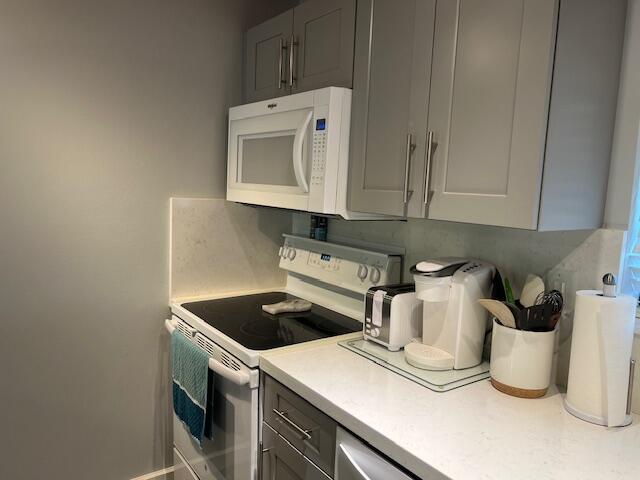 87465 Old Highway, Unit 224 Islamorada, FL 33036 - Photo 17 of 39 a kitchen with a stove and white cabinets