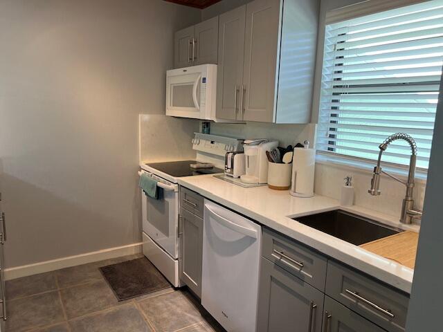 87465 Old Highway, Unit 224 Islamorada, FL 33036 - Photo 18 of 39 a kitchen with stainless steel appliances granite countertop a sink and a stove
