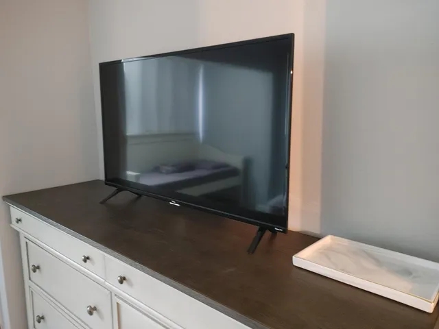 a bedroom with a large bed and a flat screen tv