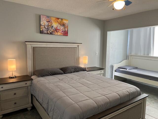 87465 Old Highway, Unit 224 Islamorada, FL 33036 - Photo 26 of 39 a bedroom with a bed and a lamp with window