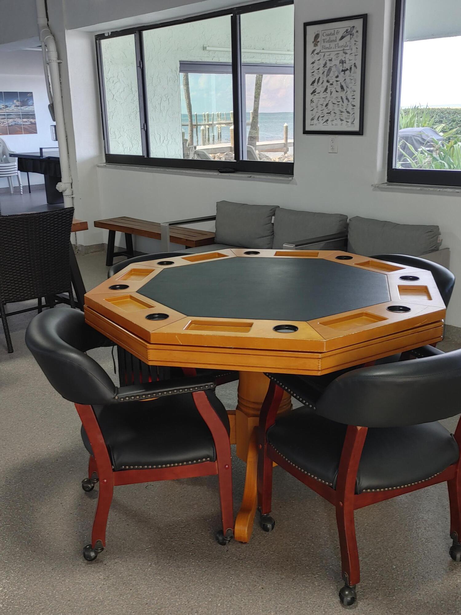 87465 Old Highway, Unit 224 Islamorada, FL 33036 - Photo 31 of 39 a room with table chairs and wooden floor