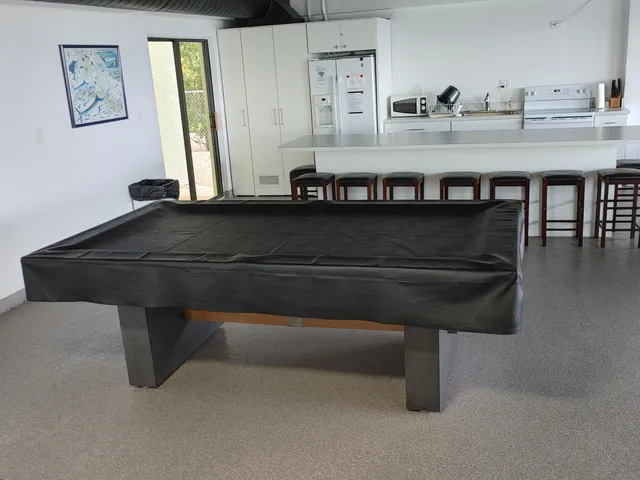 a kitchen with a table chairs sink and cabinets