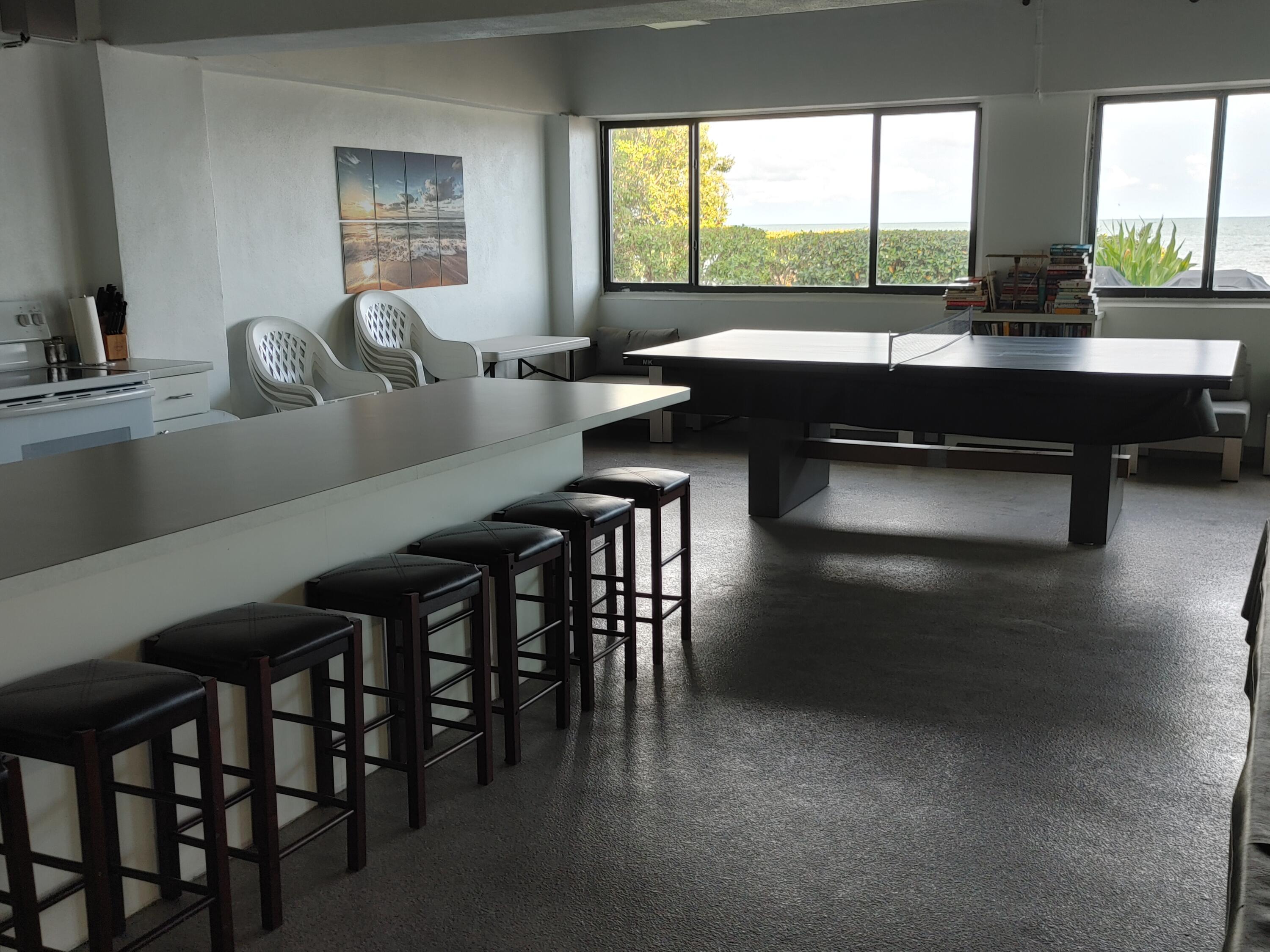 87465 Old Highway, Unit 224 Islamorada, FL 33036 - Photo 34 of 39 a kitchen with a table chairs sink and cabinets