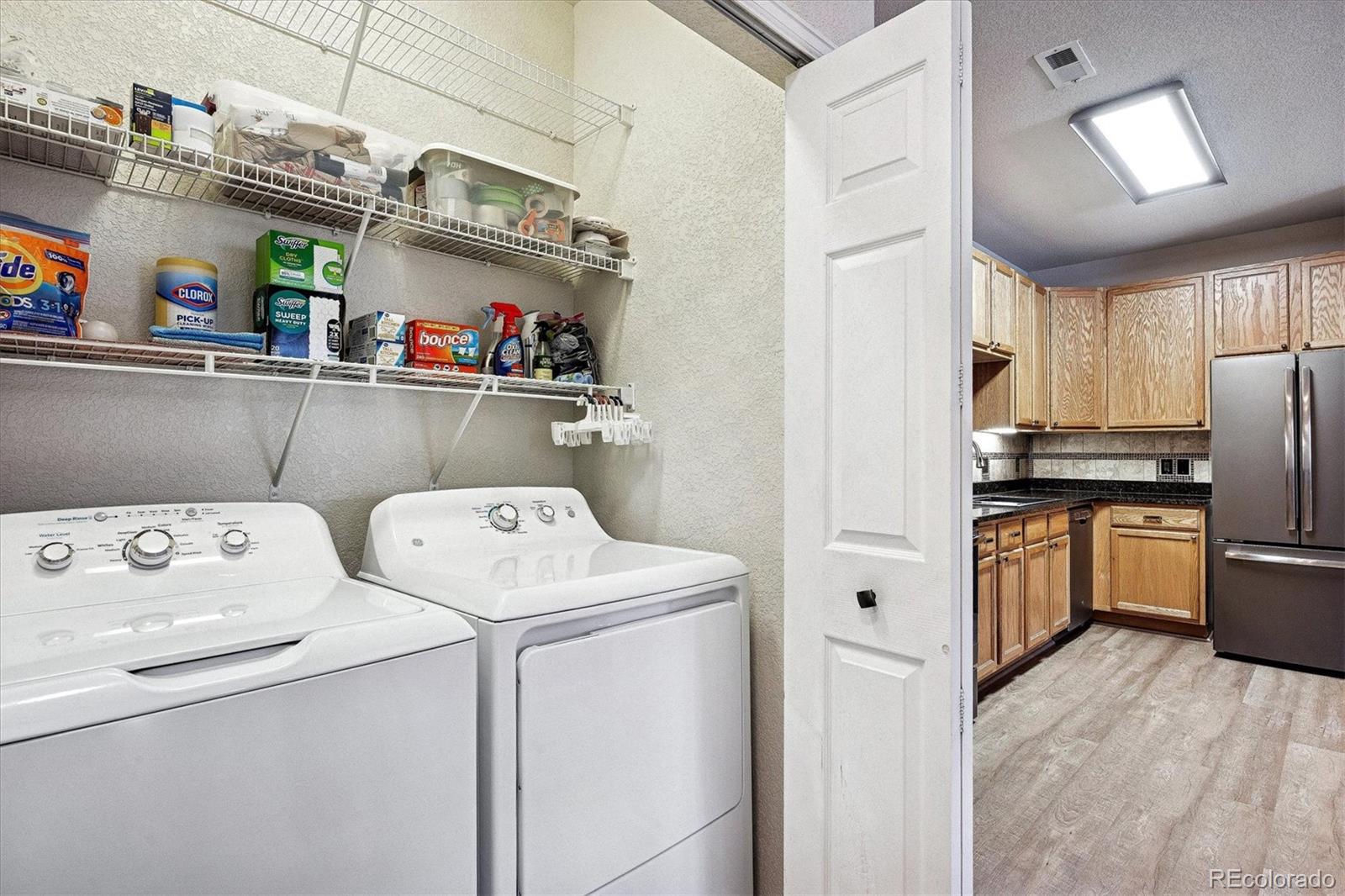 22960 East Roxbury Drive, Unit F Aurora, CO 80016 - Photo 21 of 43 a view of storage and utility room with washer and dryer