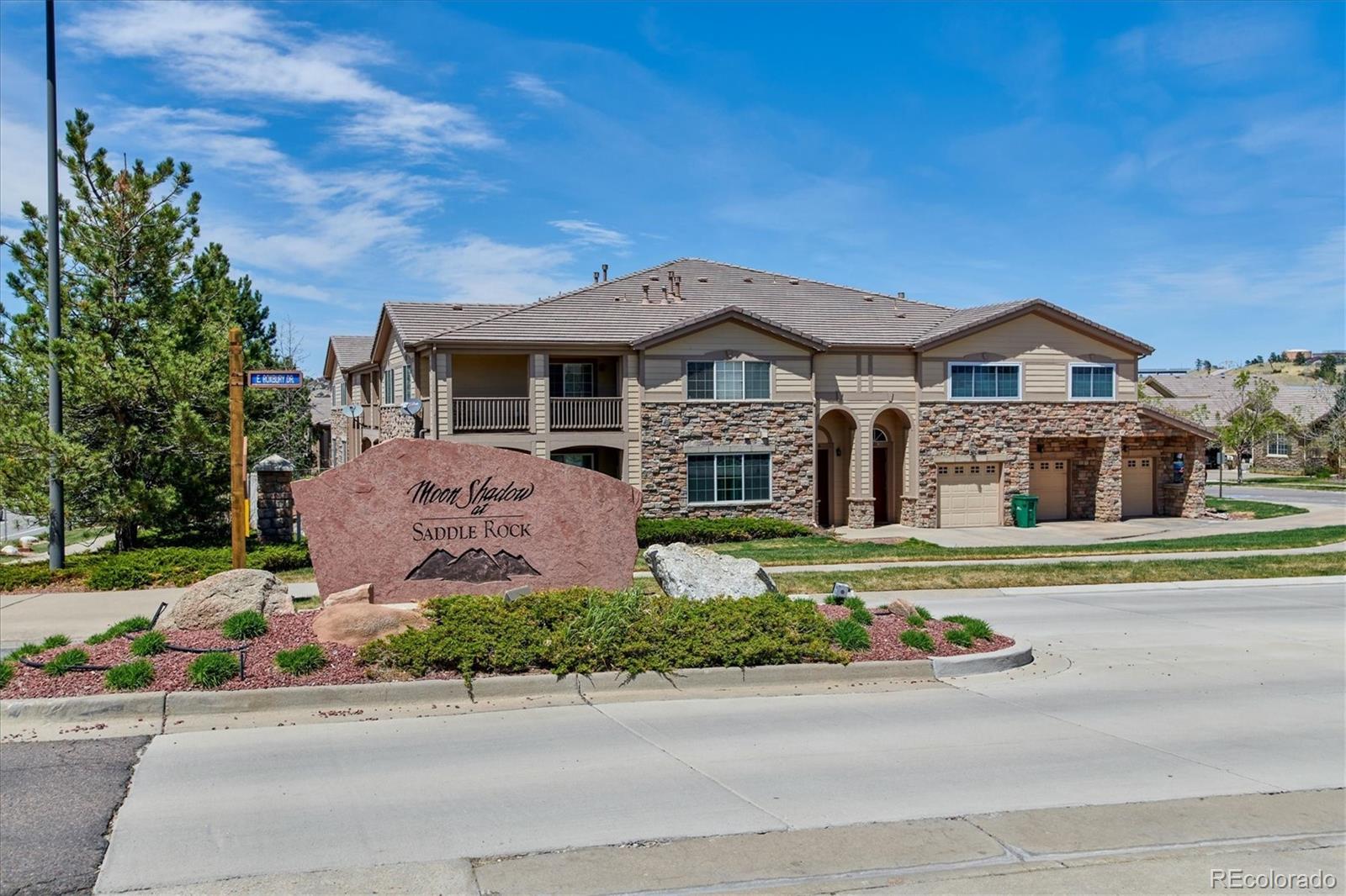 22960 East Roxbury Drive, Unit F Aurora, CO 80016 - Photo 30 of 43 a front view of a house with a garden