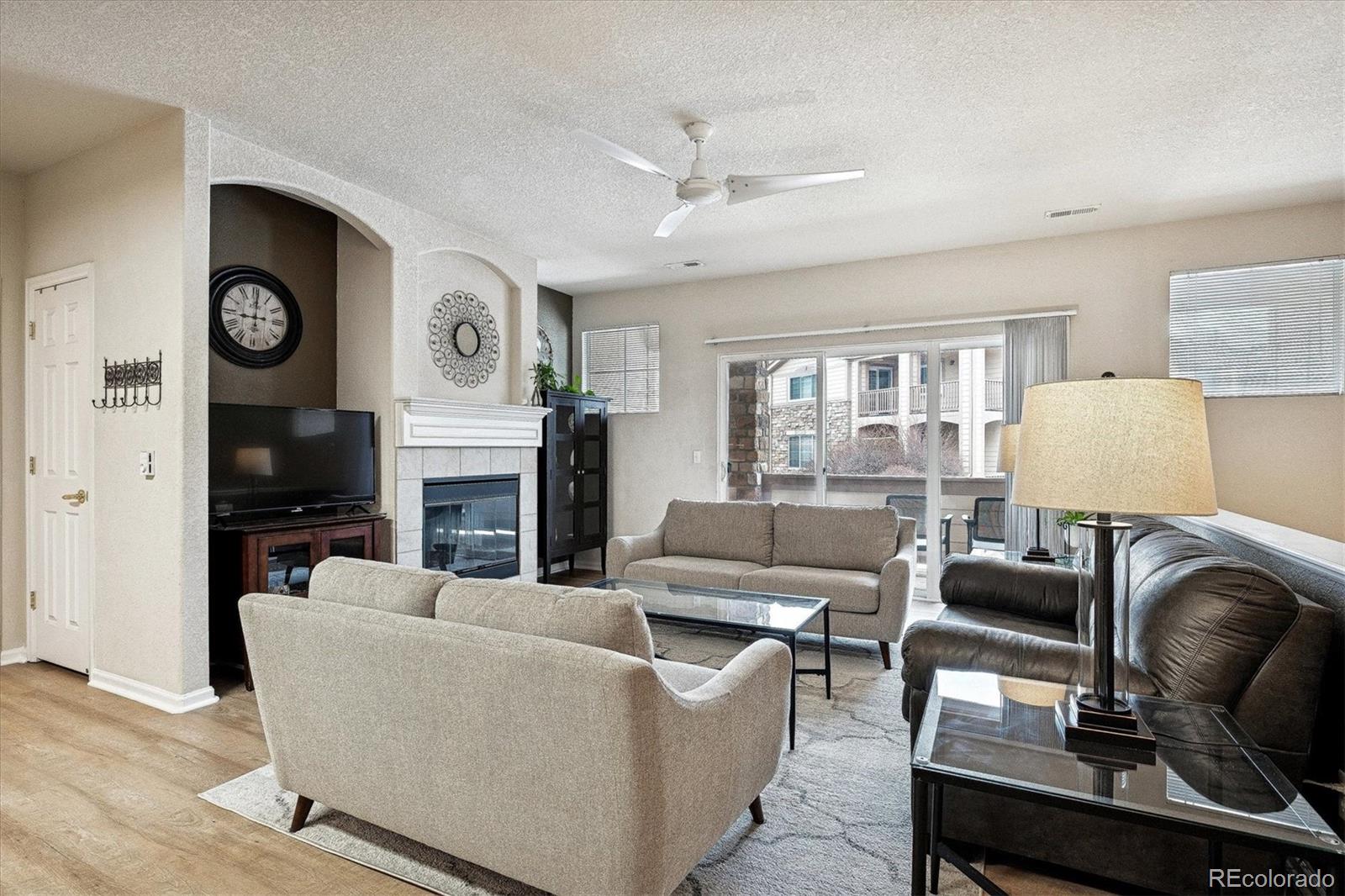 22960 East Roxbury Drive, Unit F Aurora, CO 80016 - Photo 3 of 43 a living room with furniture and a fireplace