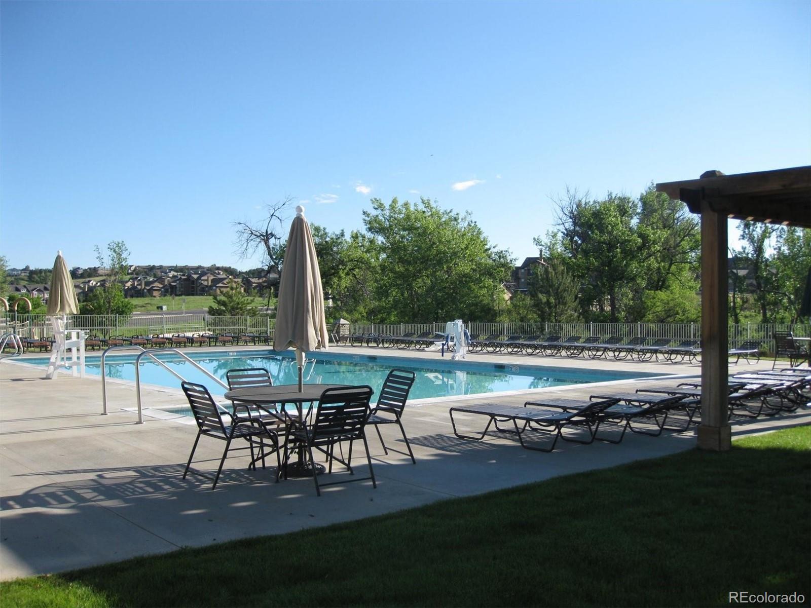 22960 East Roxbury Drive, Unit F Aurora, CO 80016 - Photo 36 of 43 a view of a patio with lawn chairs floor to ceiling window and yard