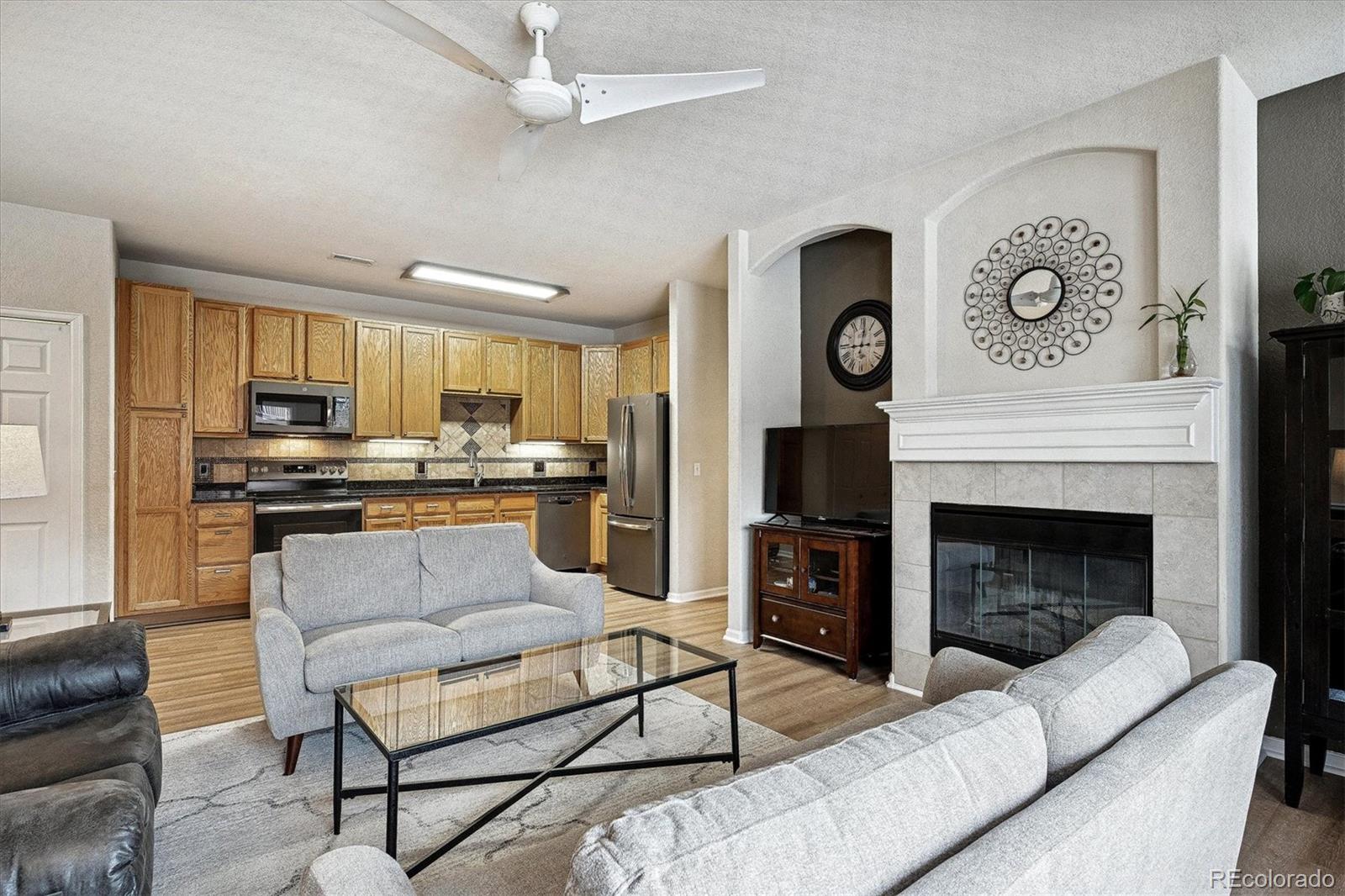 22960 East Roxbury Drive, Unit F Aurora, CO 80016 - Photo 5 of 43 a living room with furniture and a fireplace