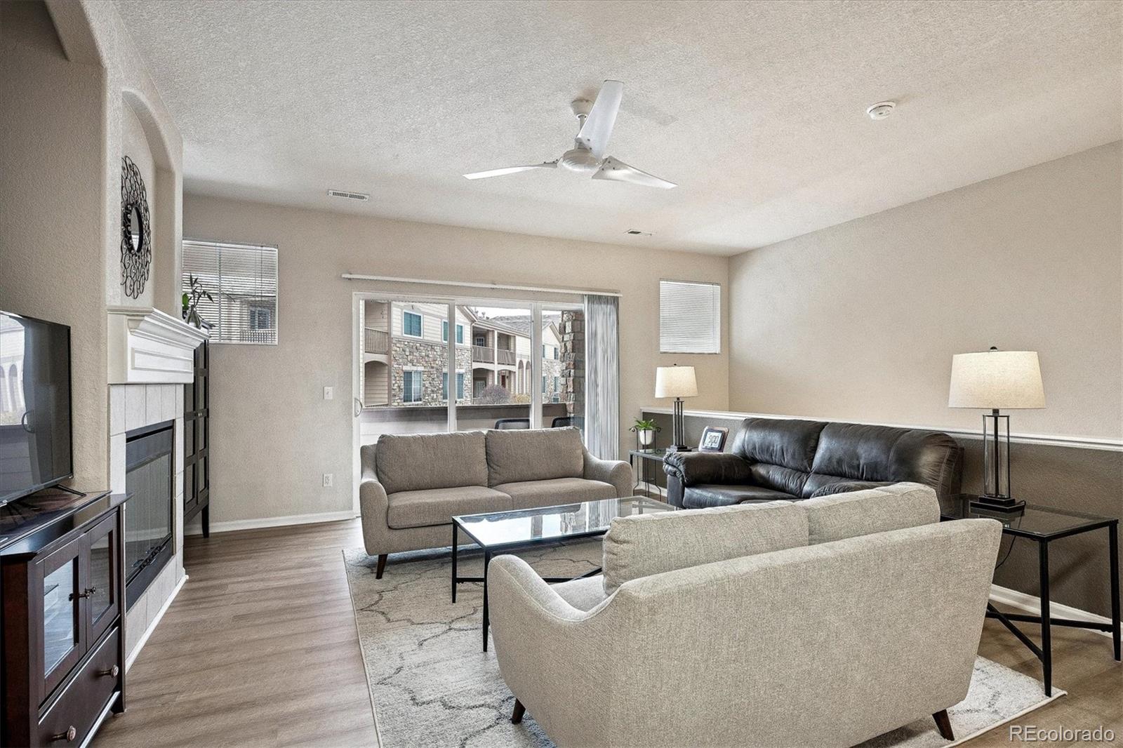 22960 East Roxbury Drive, Unit F Aurora, CO 80016 - Photo 6 of 43 a living room with furniture and a flat screen tv