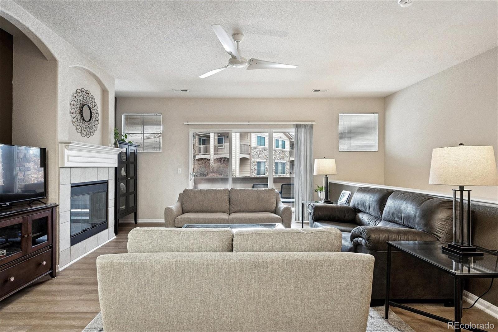 22960 East Roxbury Drive, Unit F Aurora, CO 80016 - Photo 7 of 43 a living room with furniture and a flat screen tv