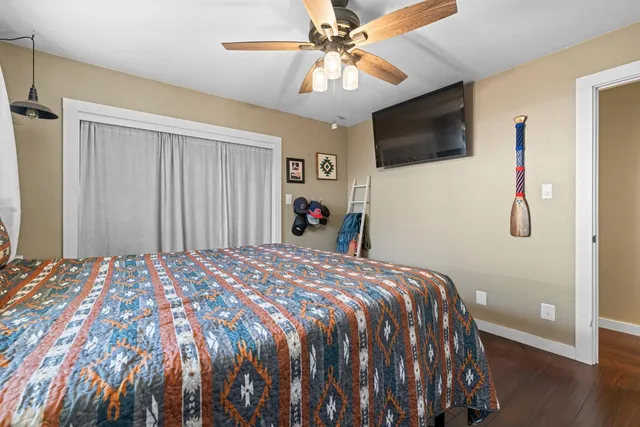 a bedroom with a bed and a flat screen tv