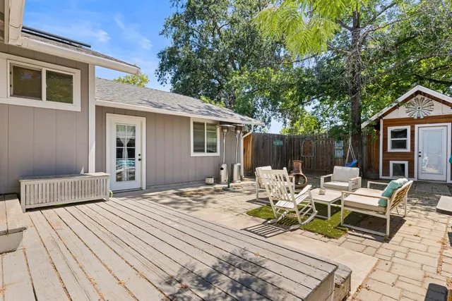 a view of backyard with a patio and outdoor seating