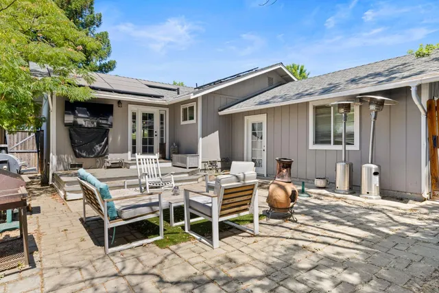 a view of a patio with table and chairs and potted plants