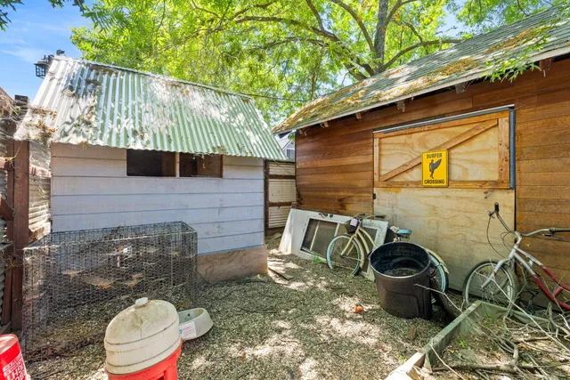 a backyard of a house with chairs and a table