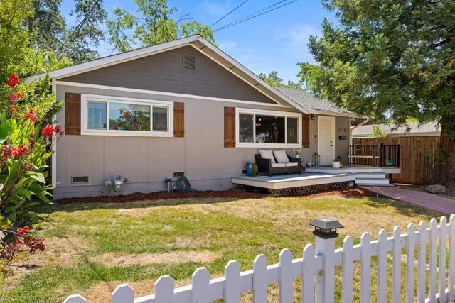 a view of a house with swimming pool and sitting area