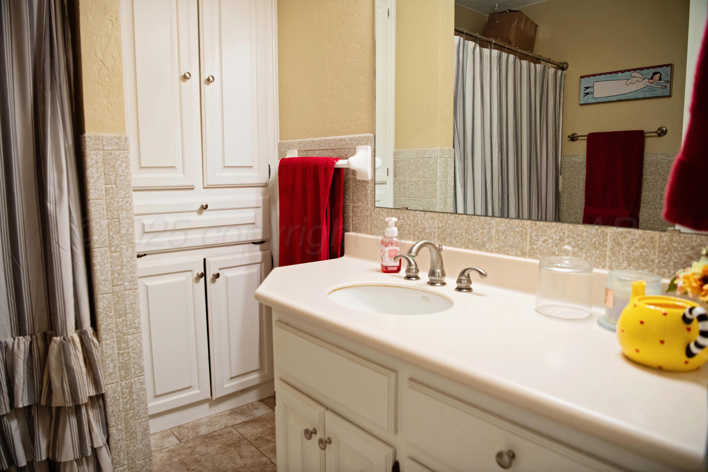 307 Douglas Street Hereford, TX 79045 - Photo 12 of 15 a bathroom with a sink and a mirror