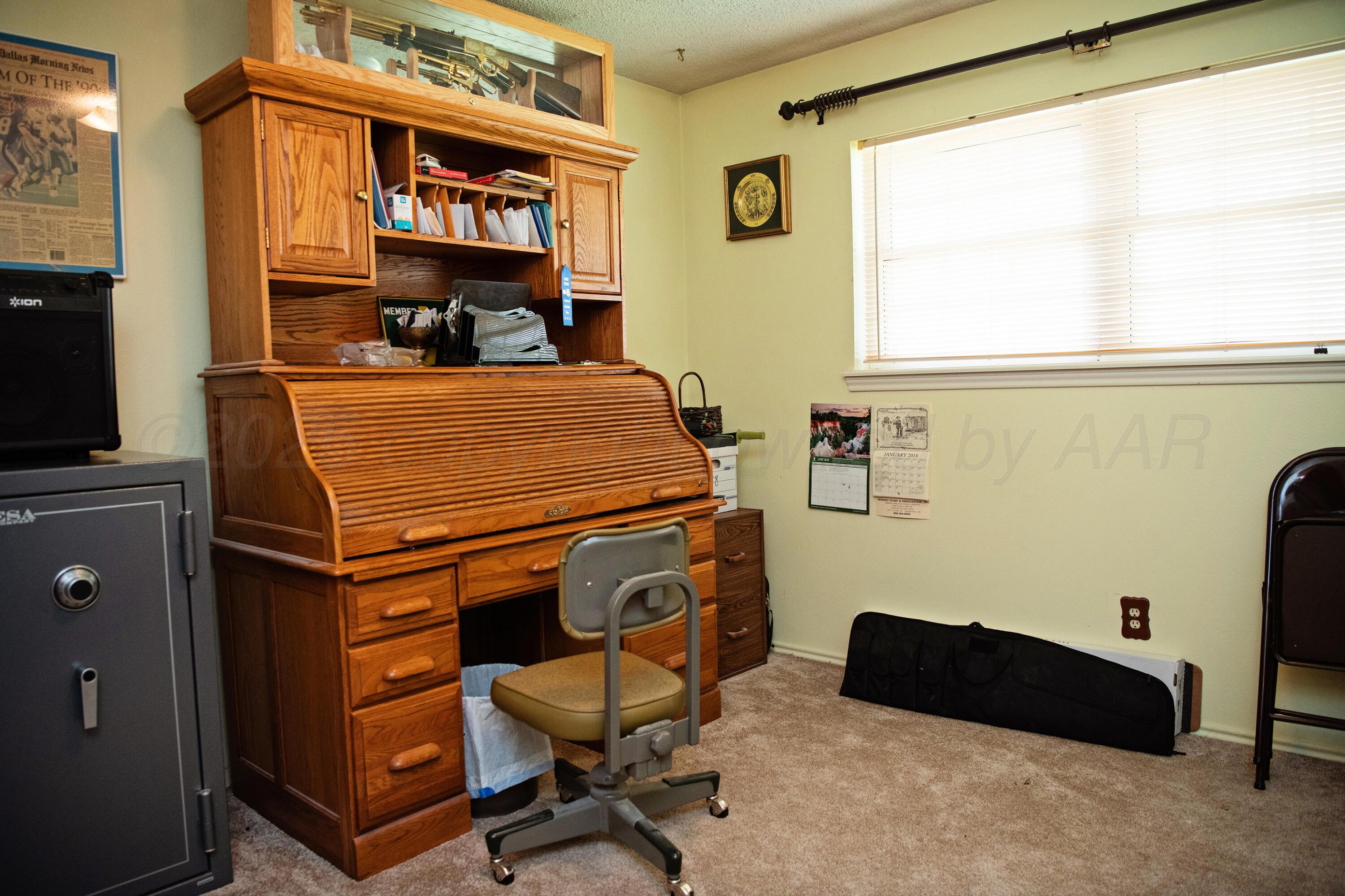 307 Douglas Street Hereford, TX 79045 - Photo 13 of 15 a room with furniture and a flat screen tv