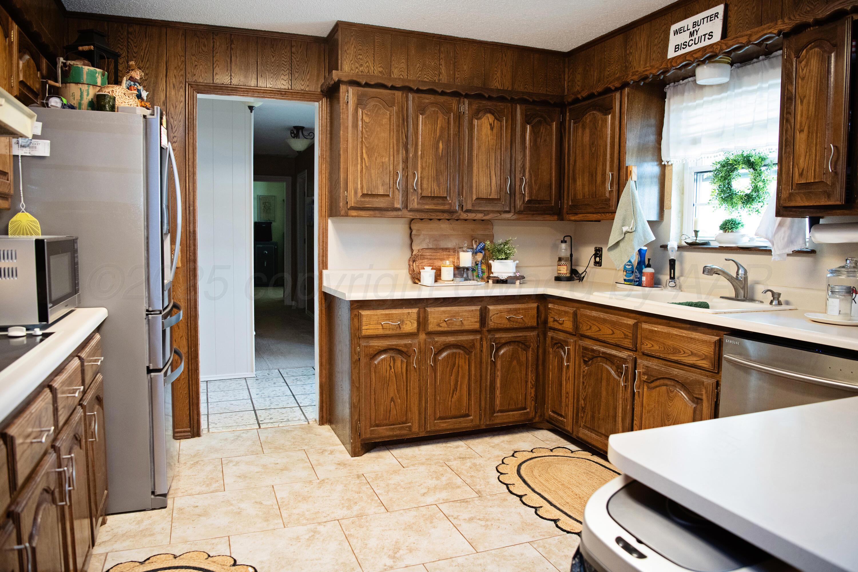 307 Douglas Street Hereford, TX 79045 - Photo 6 of 15 a kitchen with a sink stove and cabinets