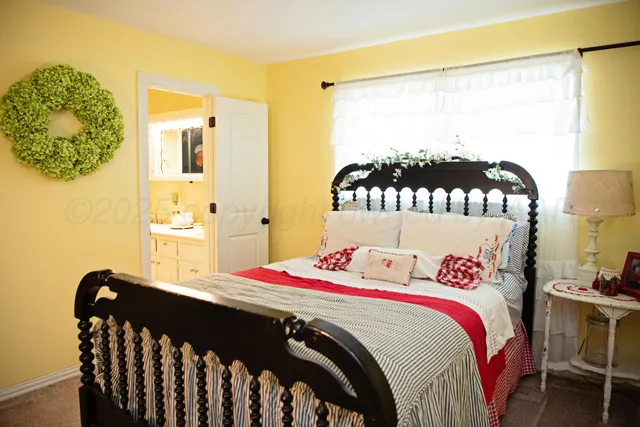 a bed sitting in a bedroom next to a window