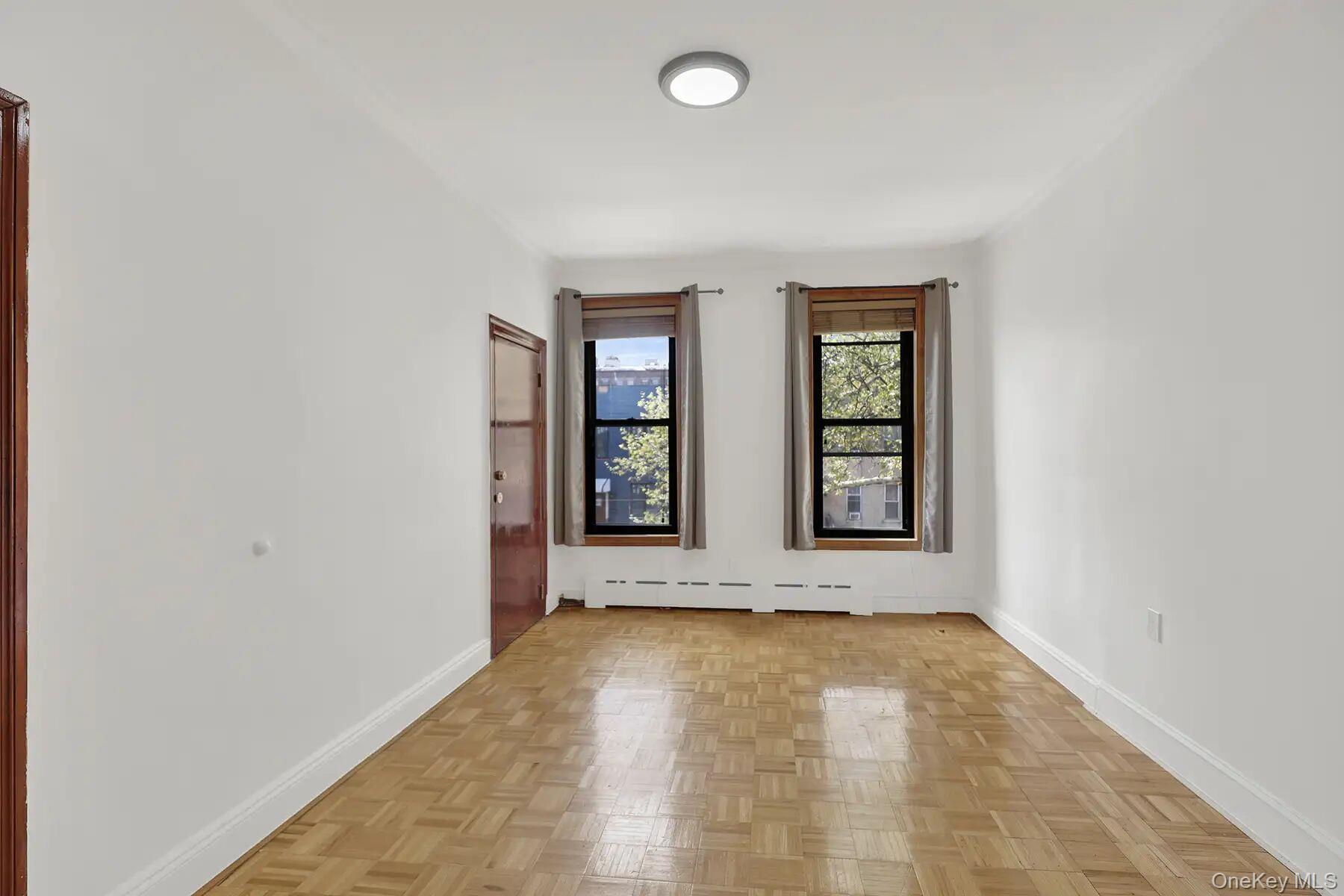 149 A 31st Street, Unit 2 Brooklyn, NY 11232 - Photo 2 of 8 an empty room with windows