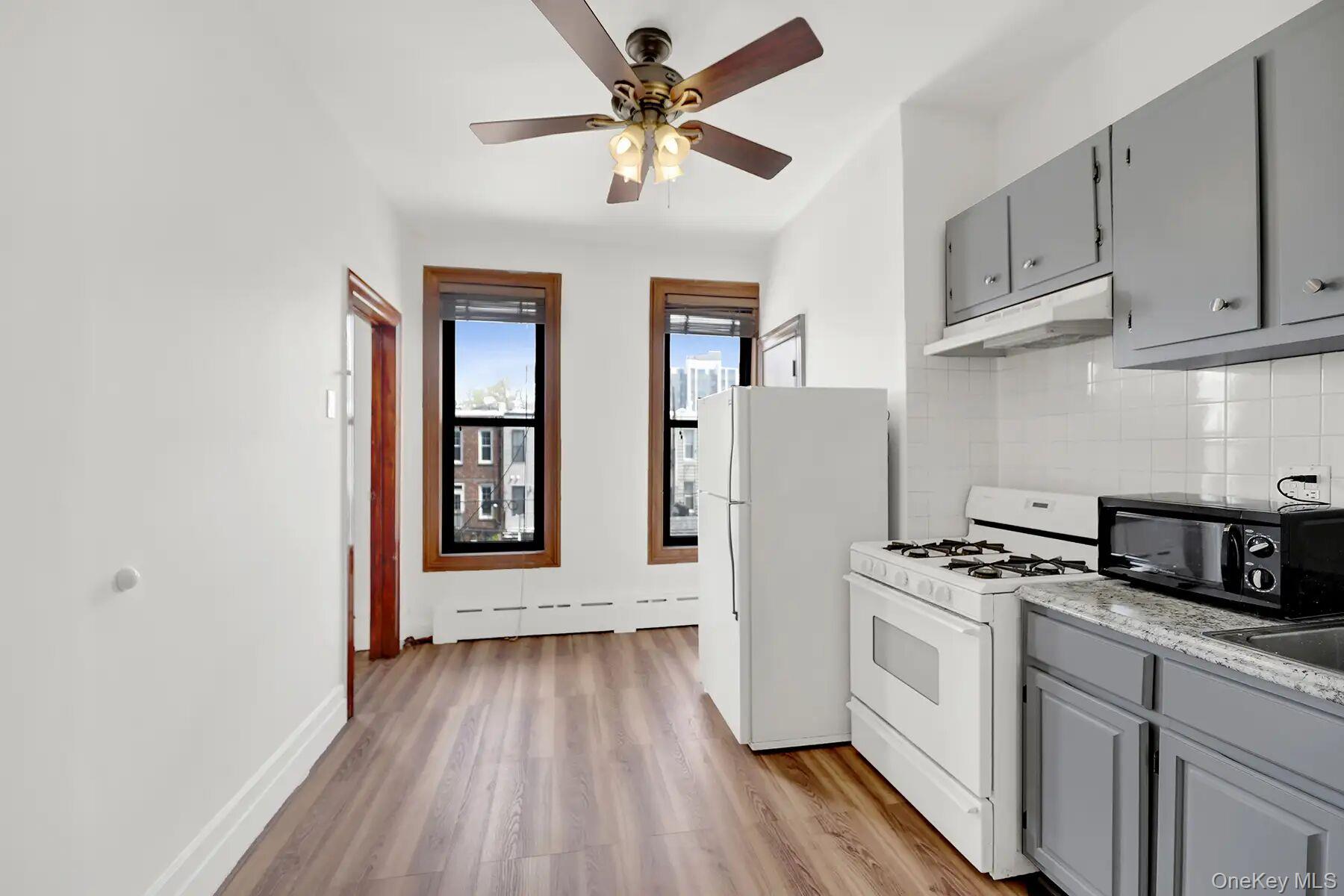 149 A 31st Street, Unit 2 Brooklyn, NY 11232 - Photo 3 of 8 a kitchen with stainless steel appliances granite countertop a stove a sink and a refrigerator