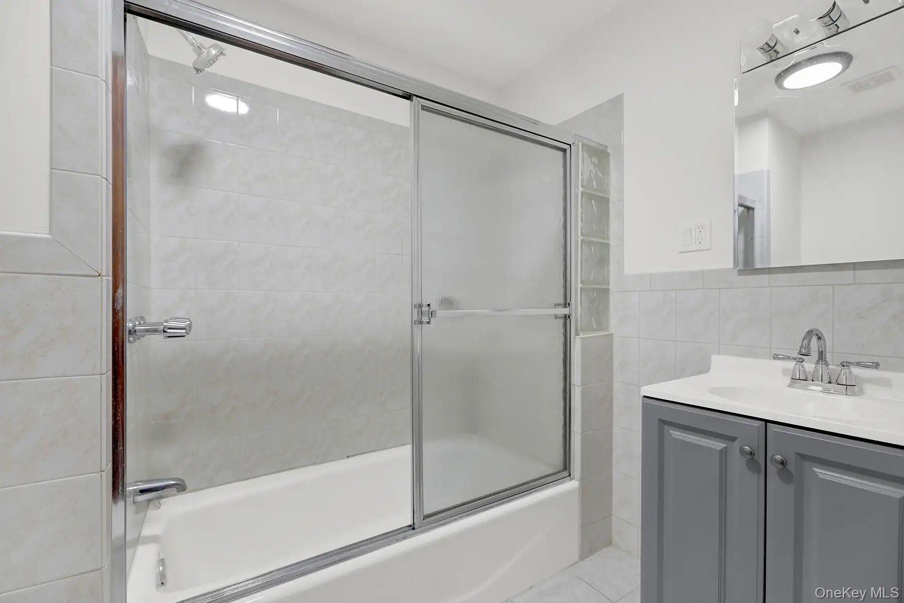 149 A 31st Street, Unit 2 Brooklyn, NY 11232 - Photo 4 of 8 a bathroom with a shower and a sink