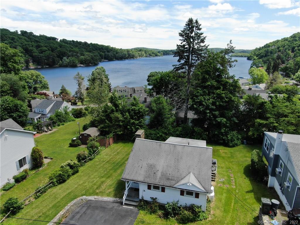 an aerial view of a house with garden space and lake view