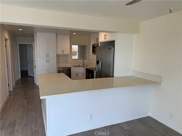 an empty room with wooden floor and glass door