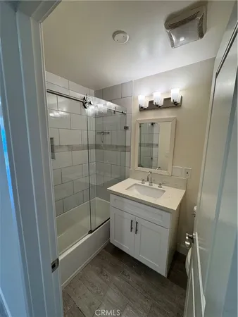 a view of a hallway with wooden floor and closet