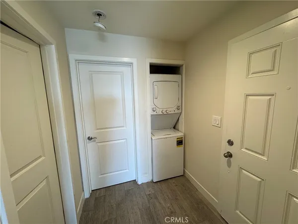 an empty room with wooden floor and window