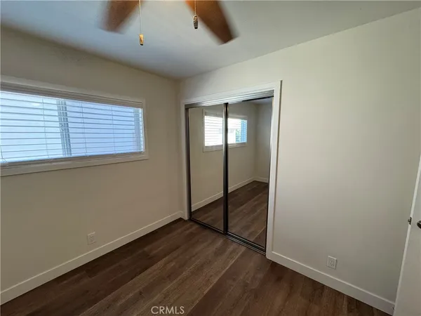 a front view of a house with a tree