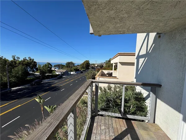 a view of a balcony with floor to ceiling windows with wooden floor