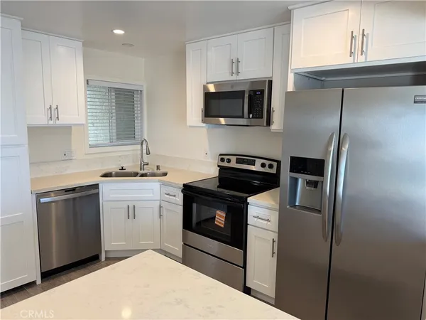 a view of kitchen island with cabinets and wooden floor