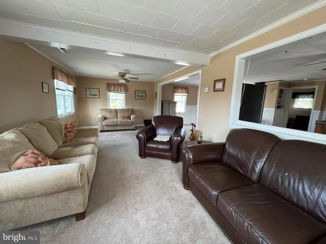 a view of a livingroom with furniture and a ceiling fan