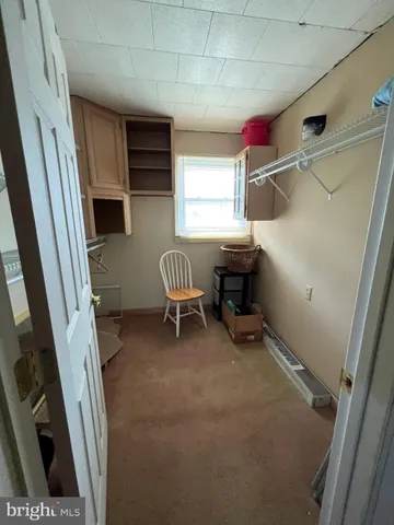 a bathroom with a tub a mirror and a shower